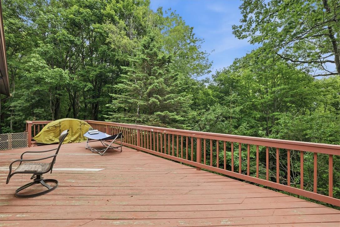 520 Highland Hill Road Jim Thorpe, PA 18235 - Photo 57 of 83 A spacious outdoor deck extends into the verdant tree canopy, creating a private arboreal retreat.