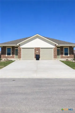 a front view of a house with a garage