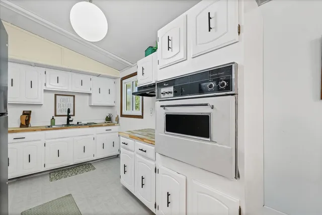 a kitchen with cabinets and appliances