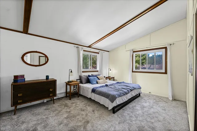 a living room with a bed furniture and a window