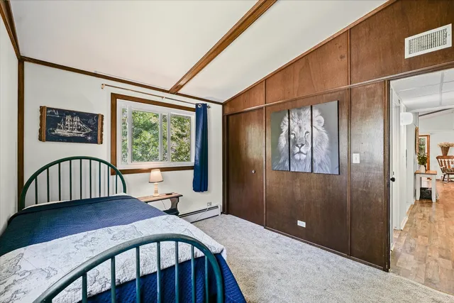 a view of a bedroom with furniture window and wooden floor
