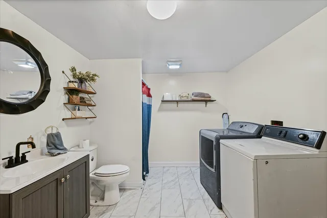 a bathroom with a toilet a sink and a mirror