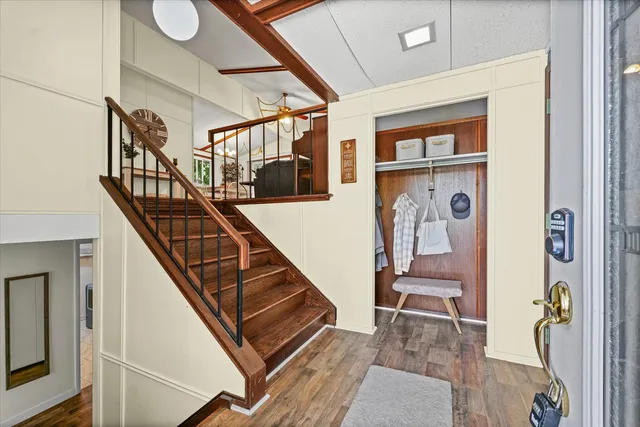 a view of staircase with lots of frames on wall and windows