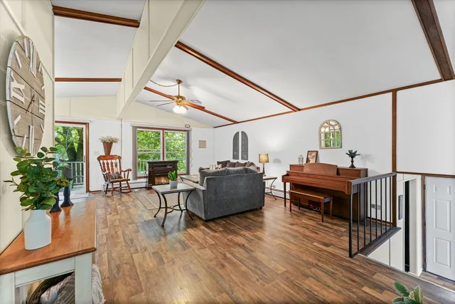 a living room with furniture fireplace and potted plants