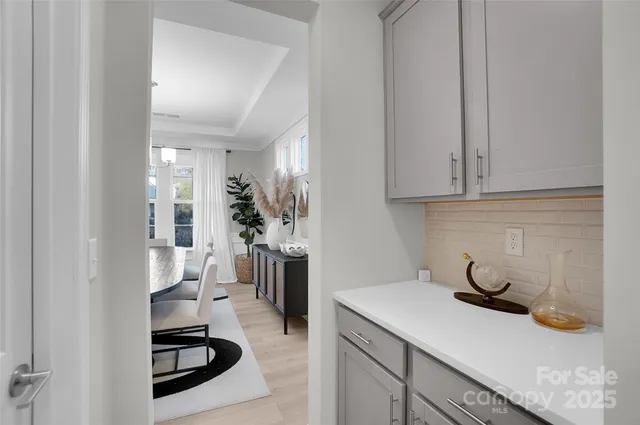 a kitchen with white cabinets and appliances