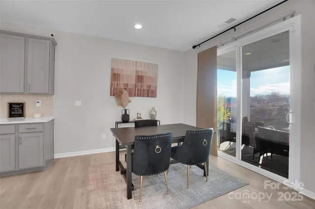 a view of a dining room with furniture and chandelier