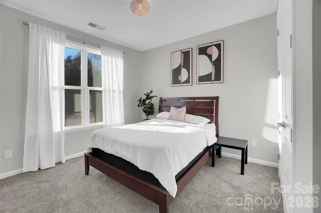 a bathroom with a granite countertop sink a toilet and a mirror