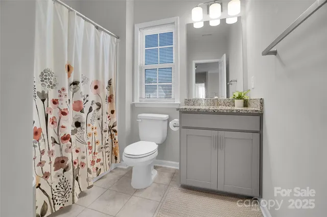 a view of a room with a white walls and a window