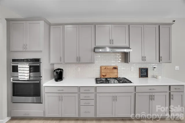 a living room with furniture and floor to ceiling windows