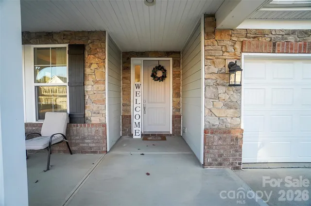a living room with furniture and white walls
