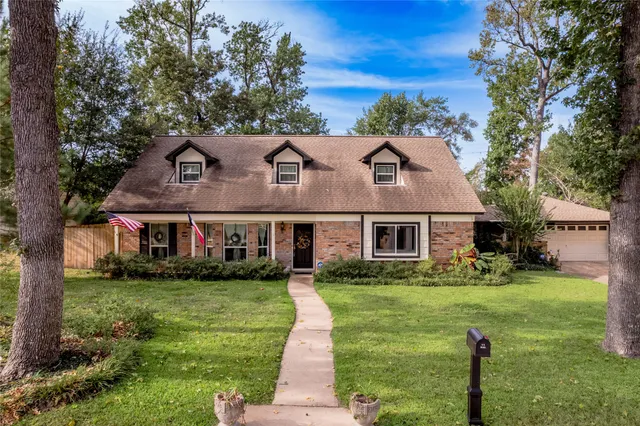 a front view of house with yard and green space