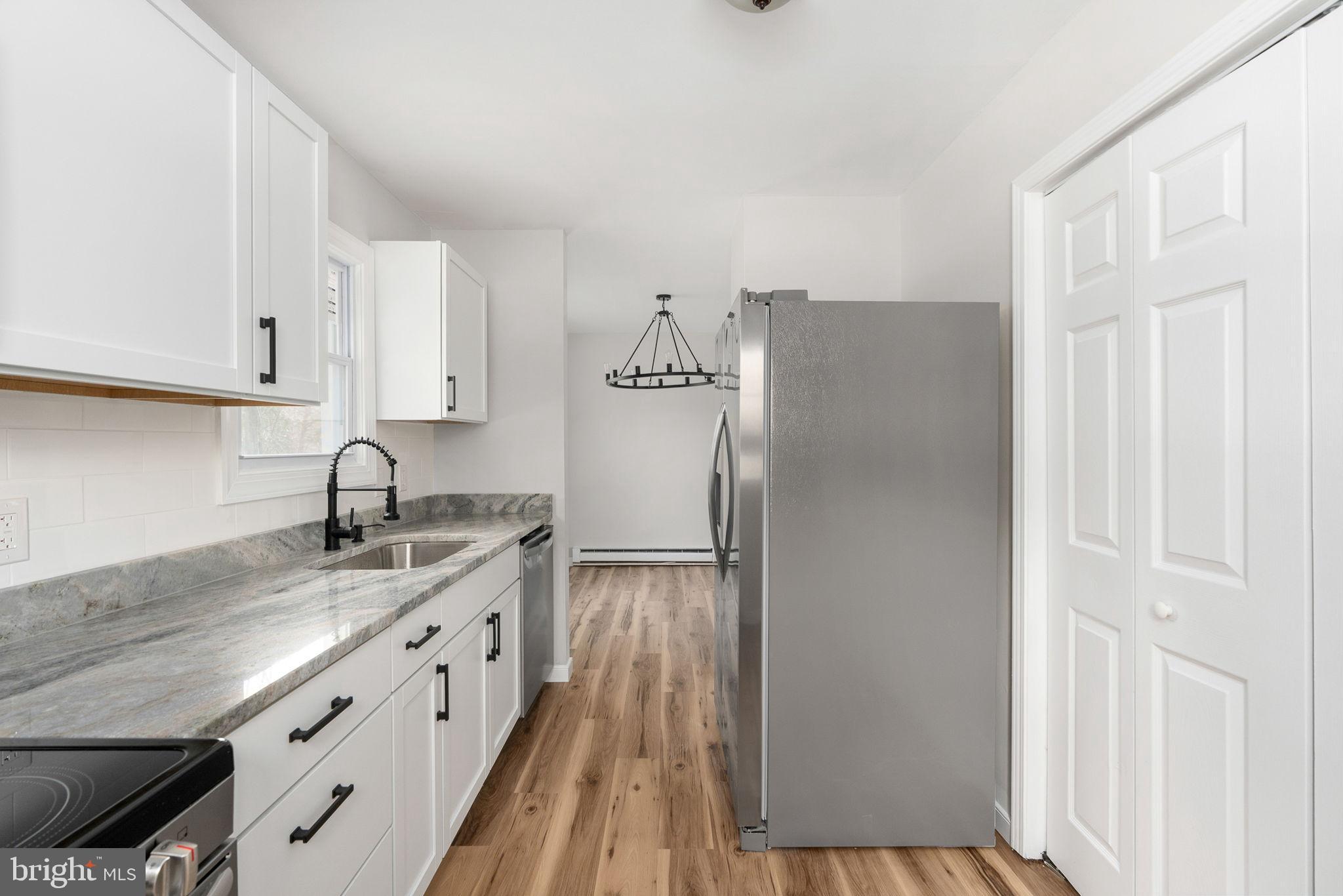 2174 Copper Line Road Bumpass, VA 23024 - Photo 16 of 45 a kitchen with granite countertop a refrigerator and a sink