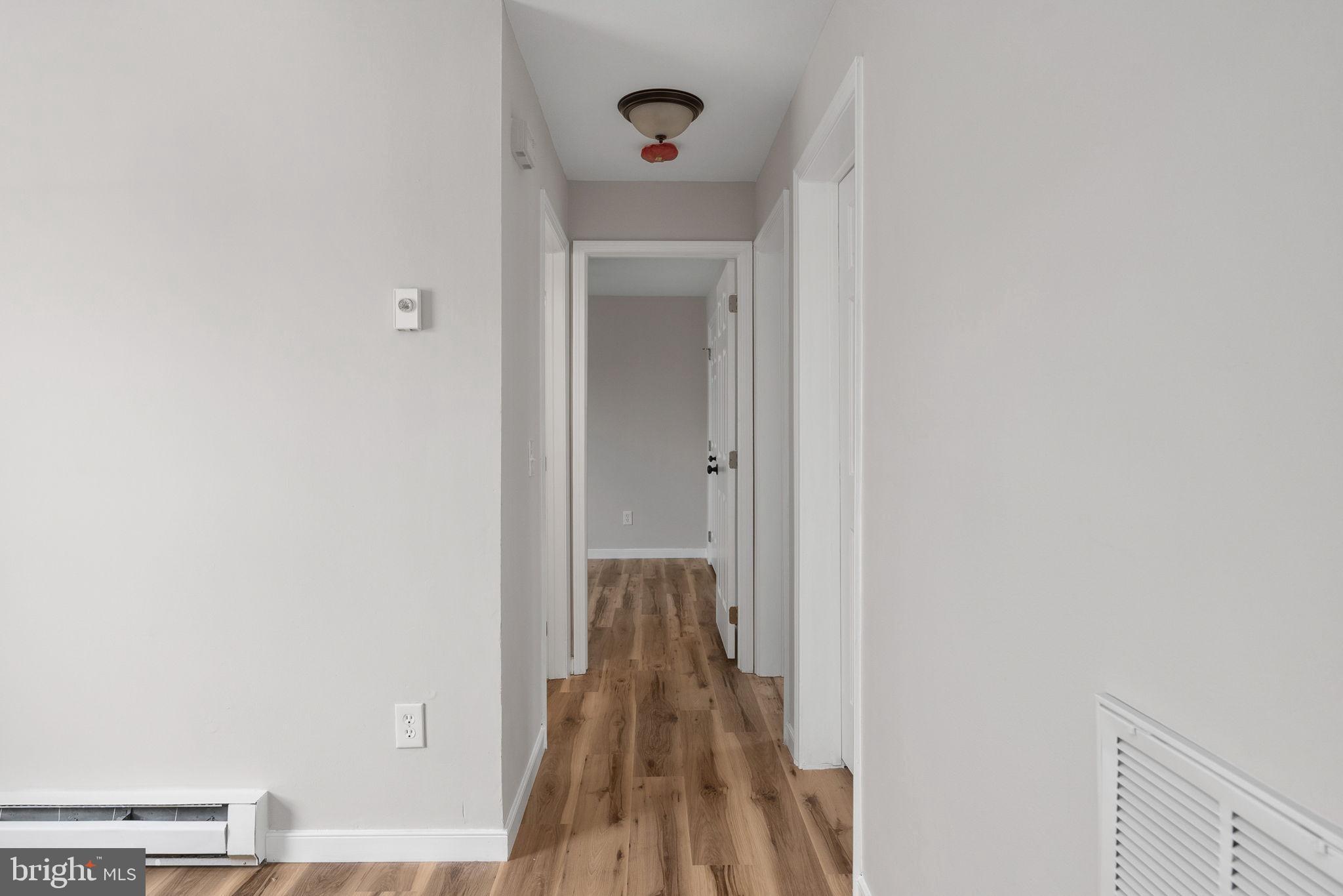 2174 Copper Line Road Bumpass, VA 23024 - Photo 18 of 45 a view of a hallway with wooden floor and a door