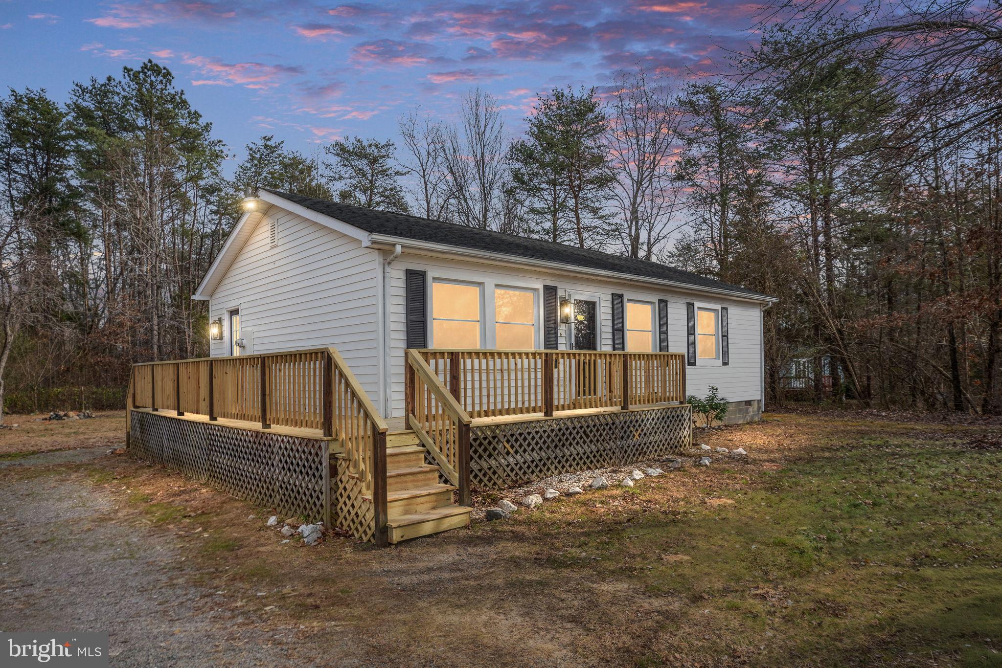 2174 Copper Line Road Bumpass, VA 23024 - Photo 2 of 45 a view of a house with a yard and sitting area