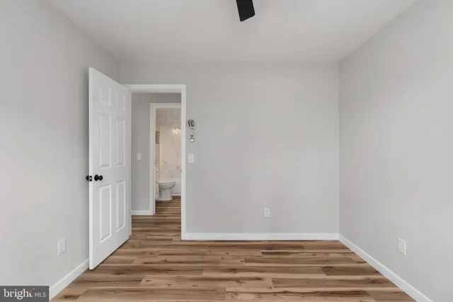 a view of a livingroom with wooden floor and a window