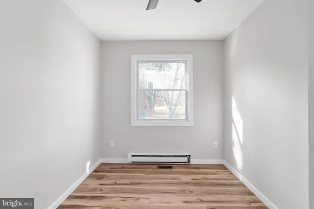 a view of a livingroom with wooden floor and a window
