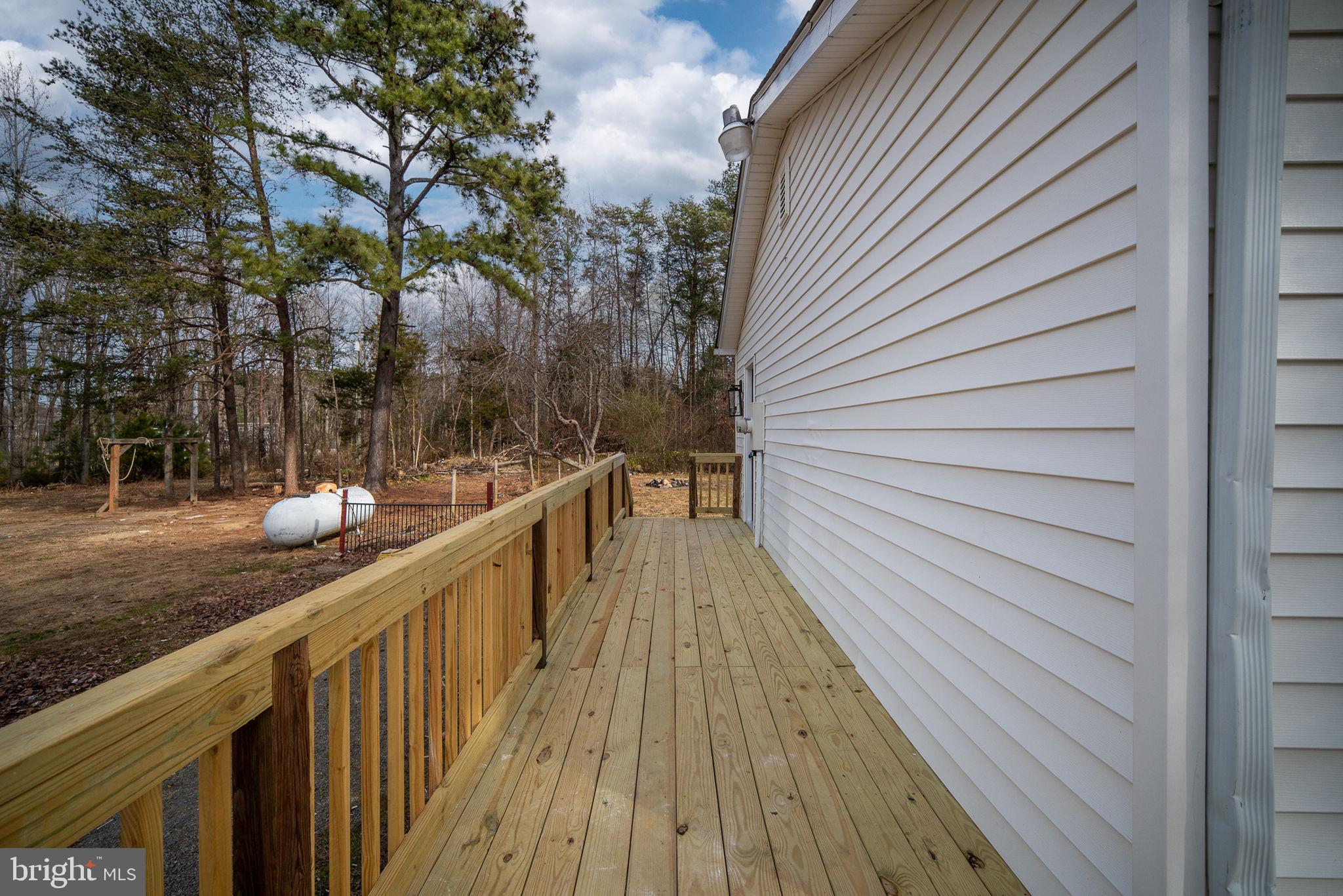 2174 Copper Line Road Bumpass, VA 23024 - Photo 37 of 45 a view of a balcony with wooden floor and fence