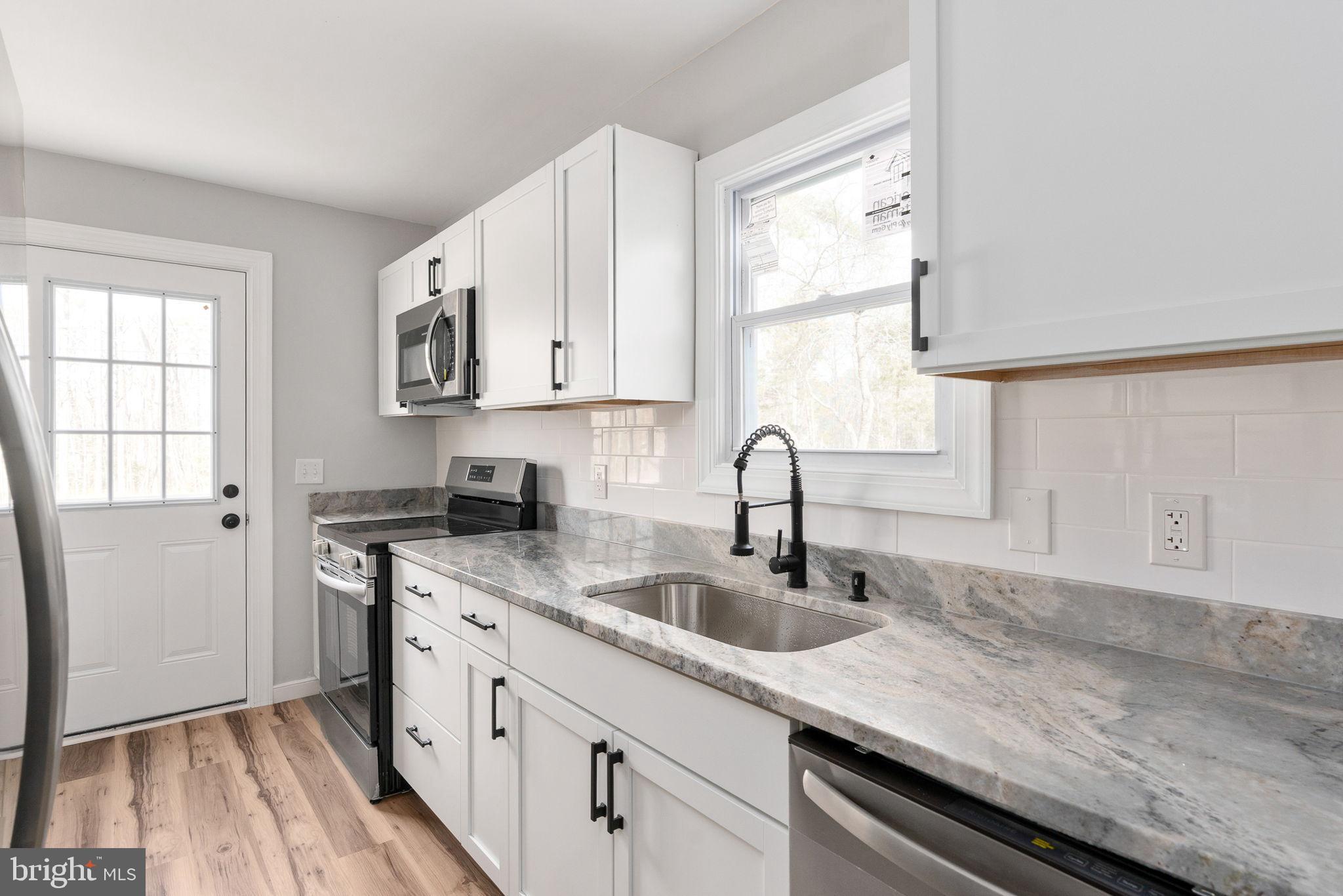 2174 Copper Line Road Bumpass, VA 23024 - Photo 6 of 45 Modern kitchen with sleek finishes.