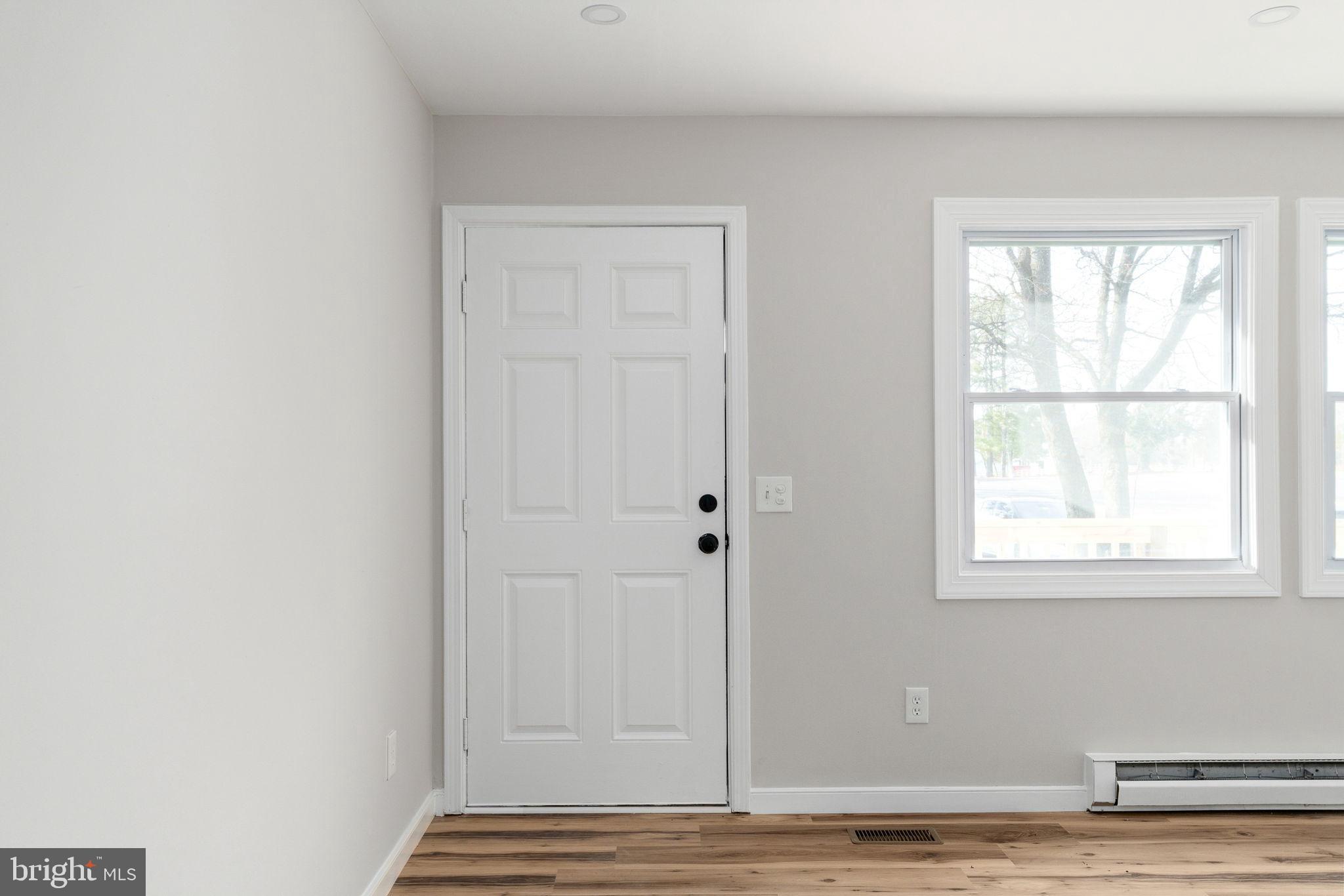 2174 Copper Line Road Bumpass, VA 23024 - Photo 7 of 45 a view of an empty room with wooden floor and a window