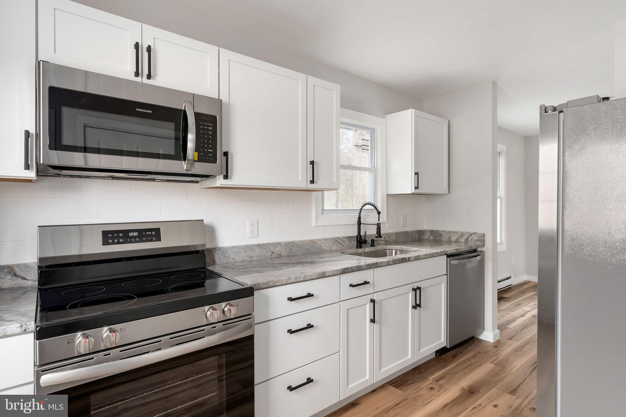 2174 Copper Line Road Bumpass, VA 23024 - Photo 9 of 45 Modern kitchen with sleek finishes.