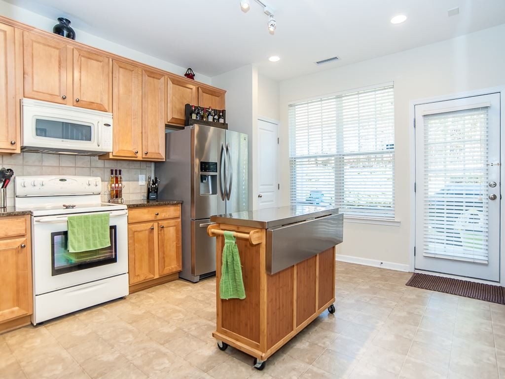 4815 Sir Duncan Way Raleigh, NC 27612 - Photo 11 of 25 Granite countertops and an upgraded Stainless Steel Refrigerator that conveys with the property. Kitchen