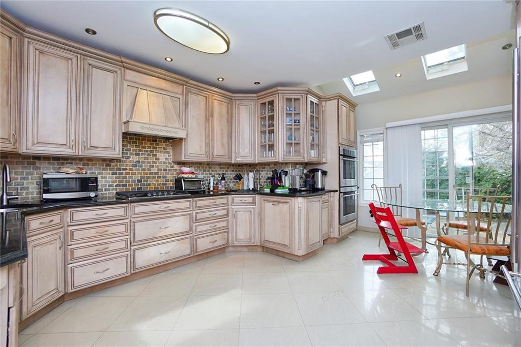 914 Avenue L Brooklyn, NY 11230 - Photo 12 of 27 a kitchen with white cabinets and sink