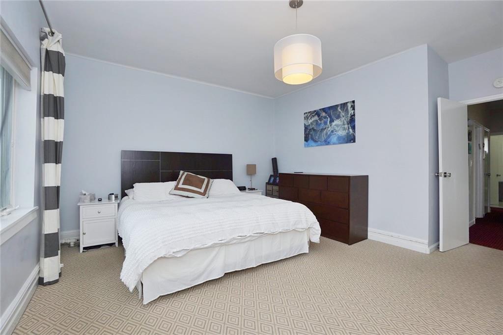 914 Avenue L Brooklyn, NY 11230 - Photo 17 of 27 a bedroom with a bed and a painting