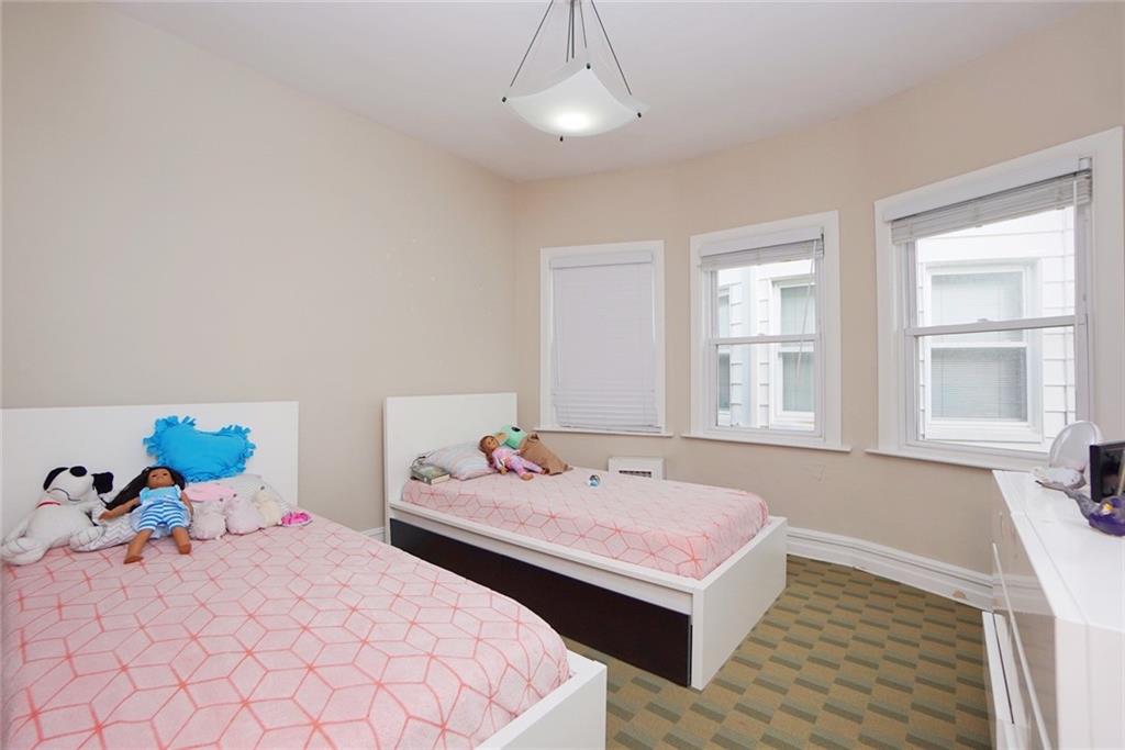 914 Avenue L Brooklyn, NY 11230 - Photo 19 of 27 a bedroom with a bed and wooden floor