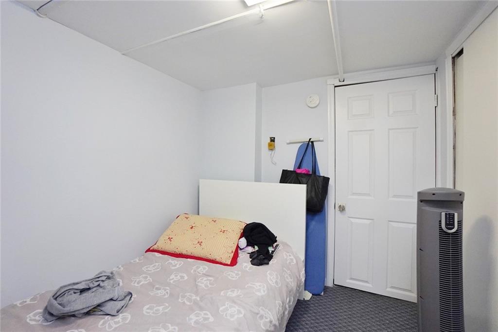 914 Avenue L Brooklyn, NY 11230 - Photo 26 of 27 a bed room with a bed and a night stand