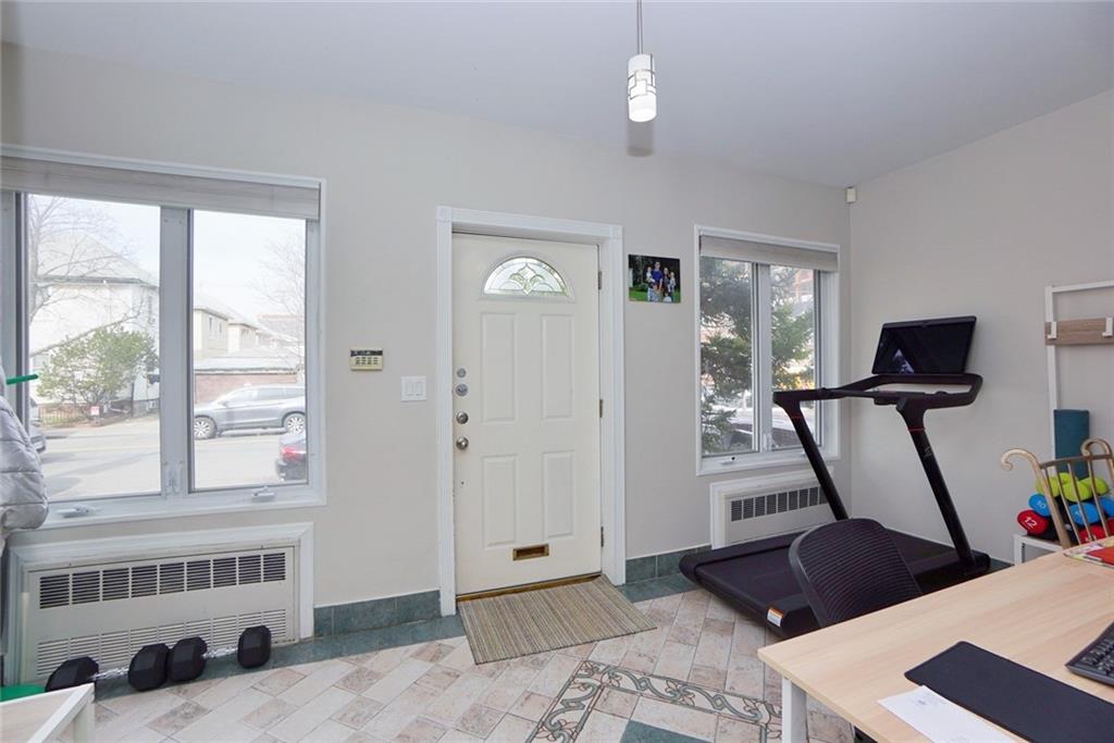 914 Avenue L Brooklyn, NY 11230 - Photo 5 of 27 a view of an empty room with wooden floor and windows