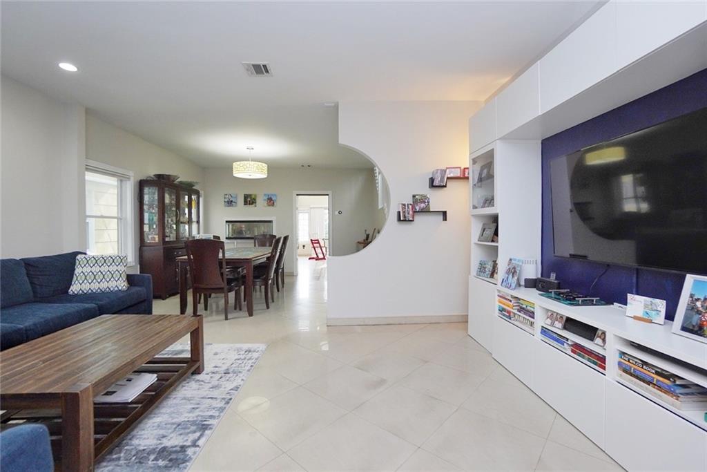 914 Avenue L Brooklyn, NY 11230 - Photo 7 of 27 a living room with furniture and a flat screen tv