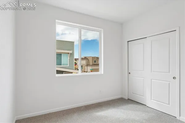a bathroom with a toilet a sink a mirror and vanity