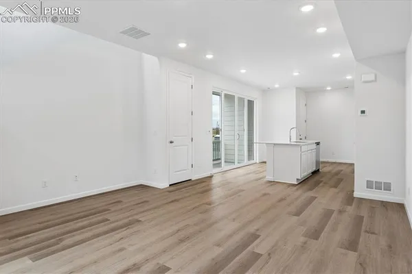 a view of a kitchen with wooden floor