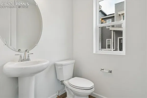 a bathroom with a sink toilet and mirror