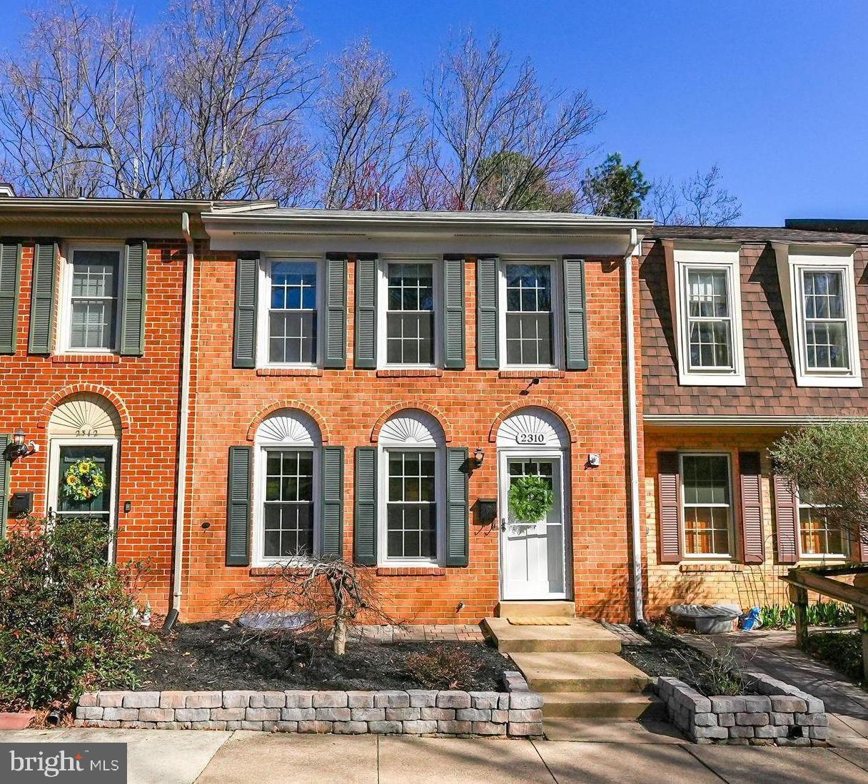 2310 Horseferry Court Reston, VA 20191 - Photo 1 of 49 front view of a brick house with a yard
