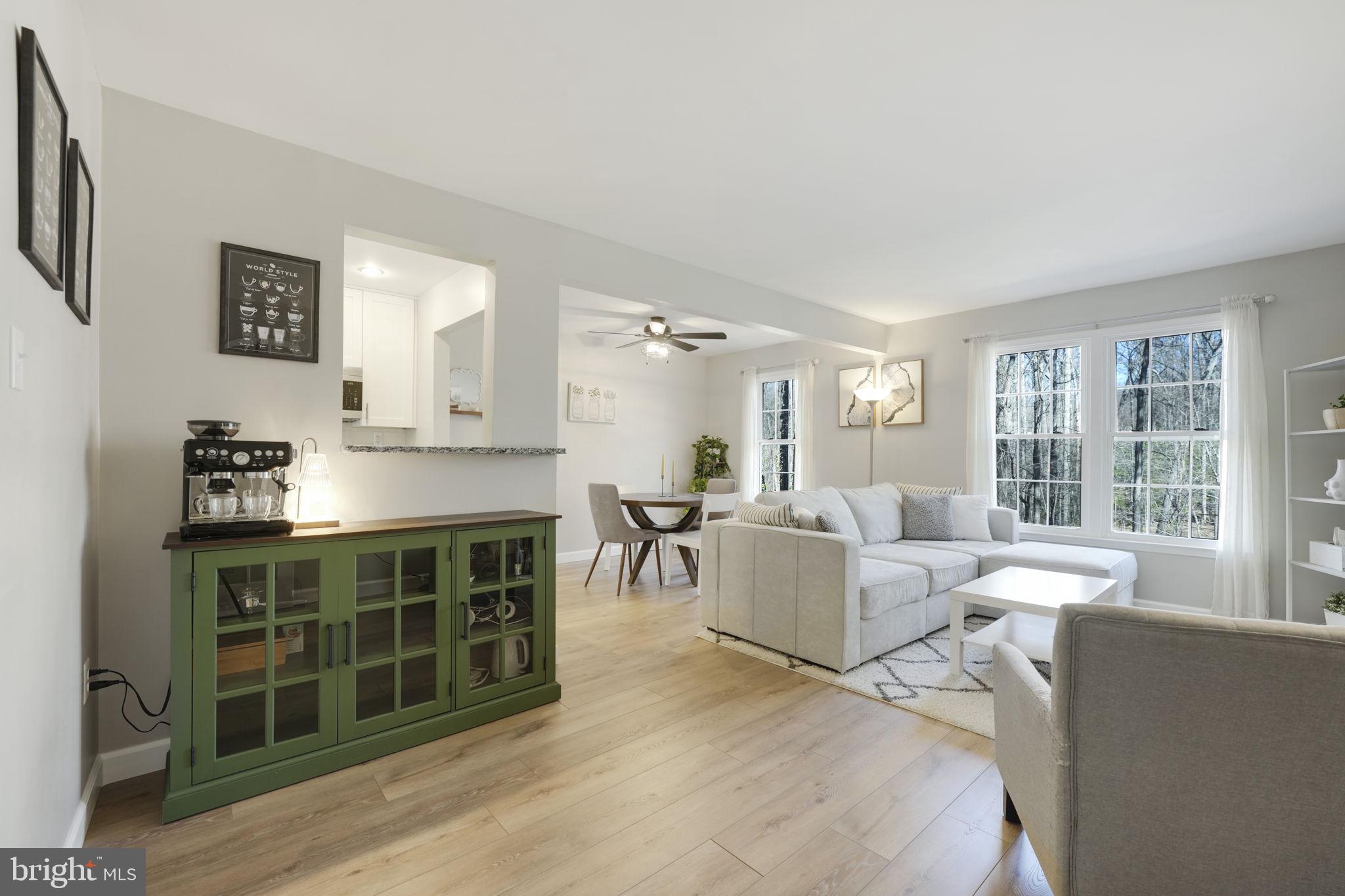 2310 Horseferry Court Reston, VA 20191 - Photo 13 of 49 a living room with furniture a dining table and a fireplace