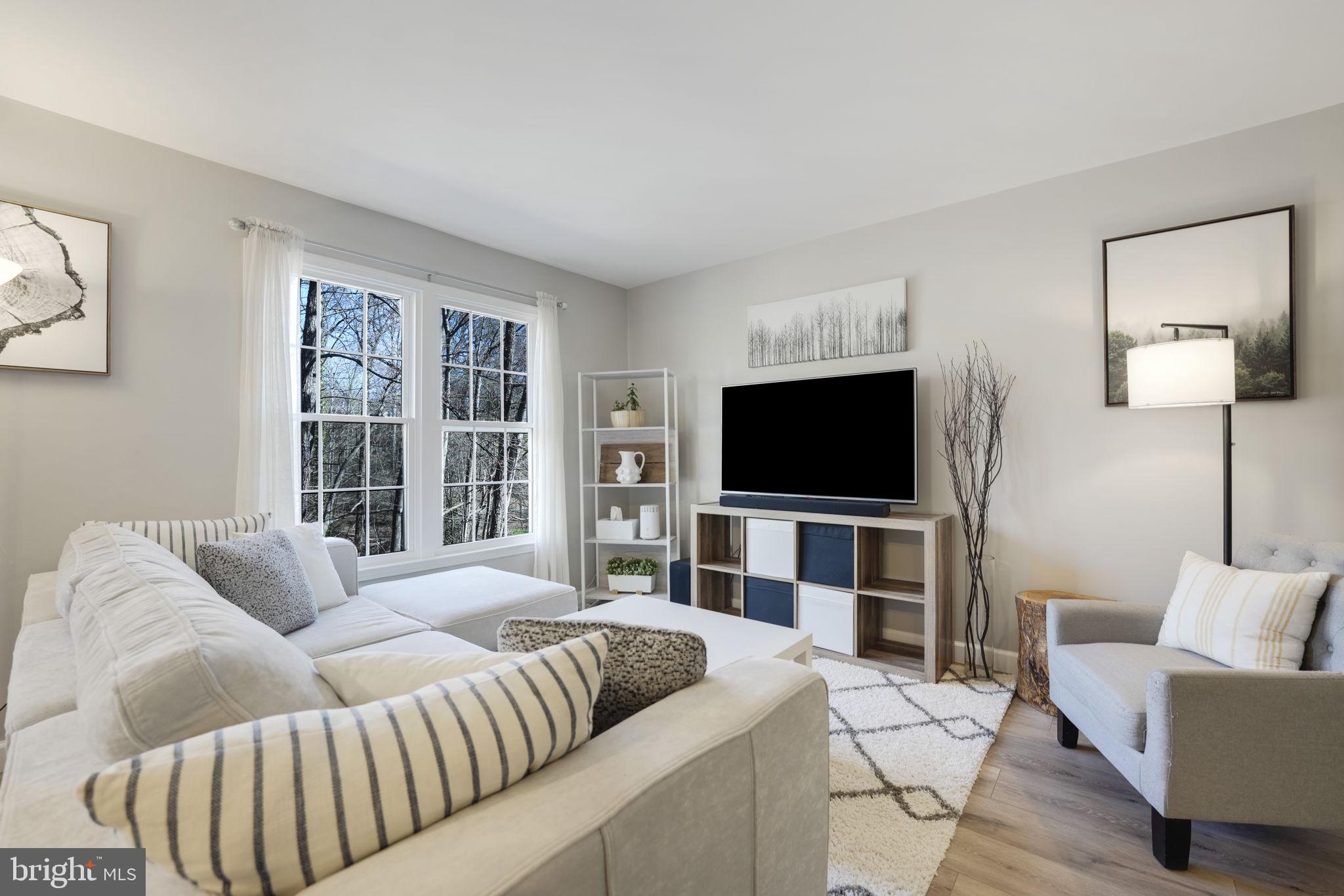 2310 Horseferry Court Reston, VA 20191 - Photo 15 of 49 a living room with furniture and a flat screen tv