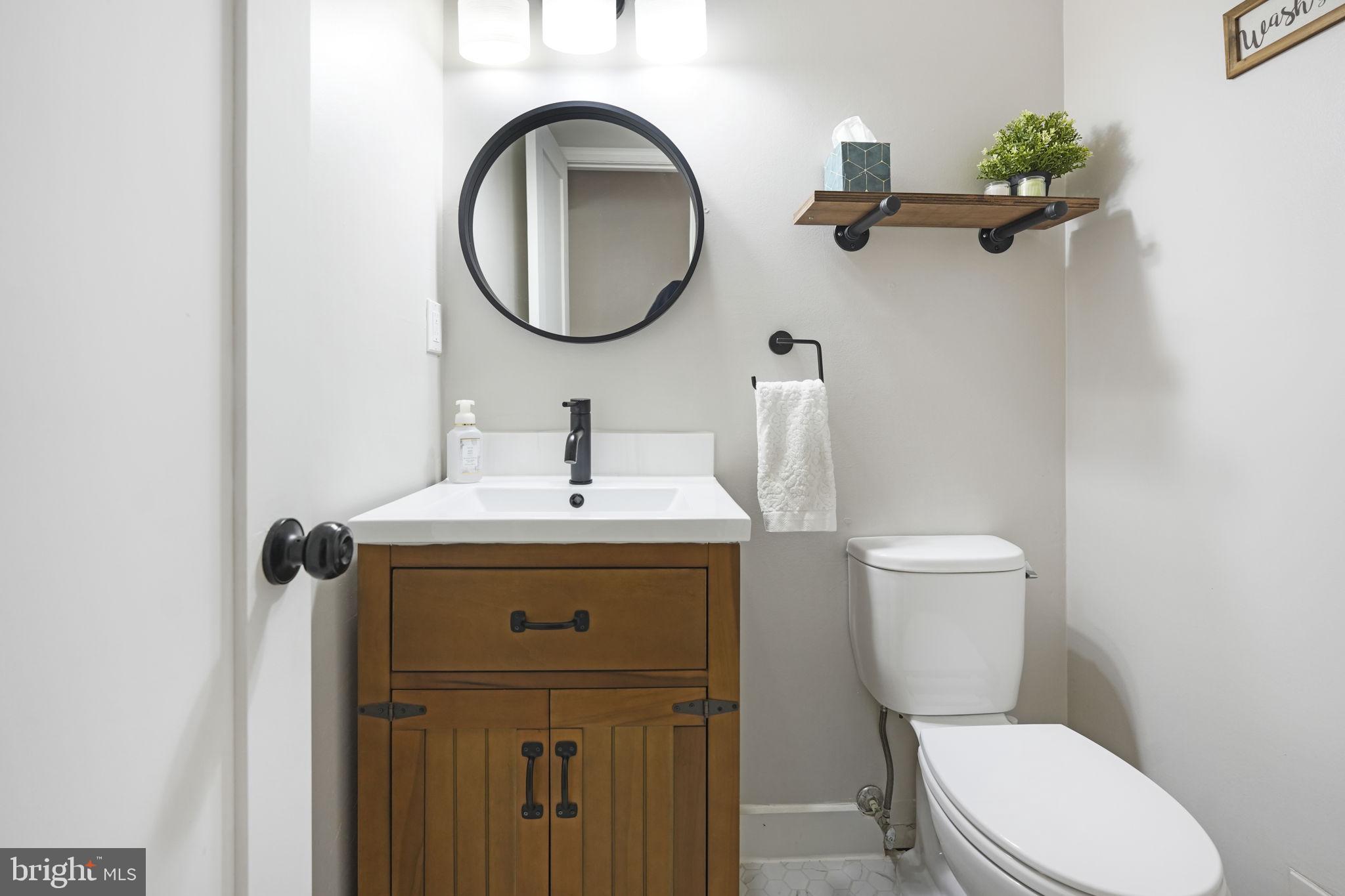 2310 Horseferry Court Reston, VA 20191 - Photo 19 of 49 a bathroom with a toilet sink and mirror