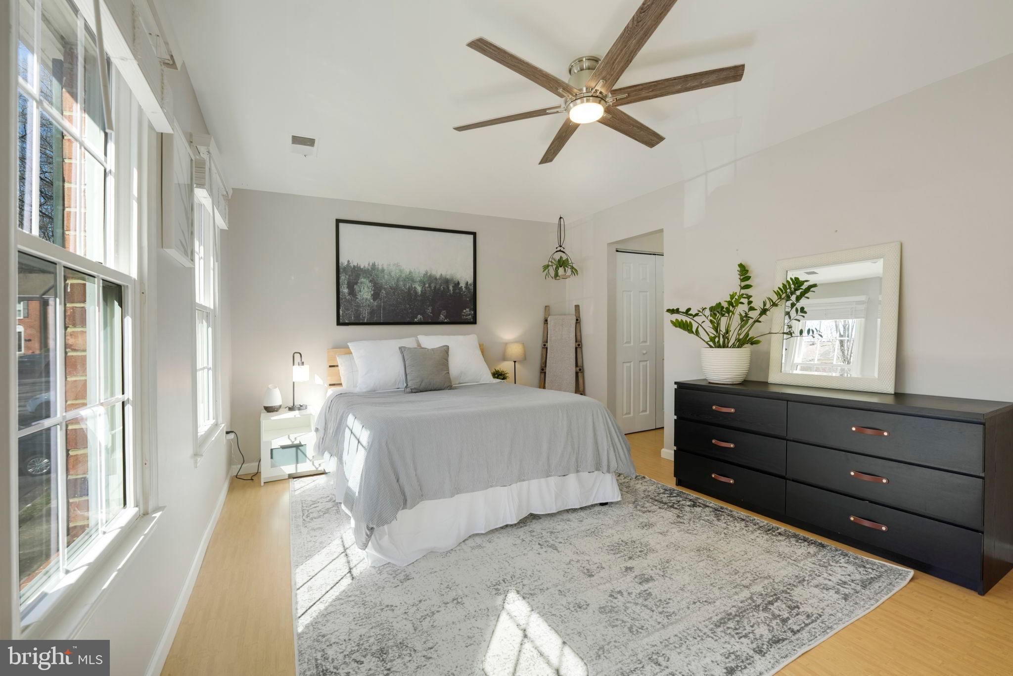 2310 Horseferry Court Reston, VA 20191 - Photo 22 of 49 a spacious bedroom with a bed and wooden floor