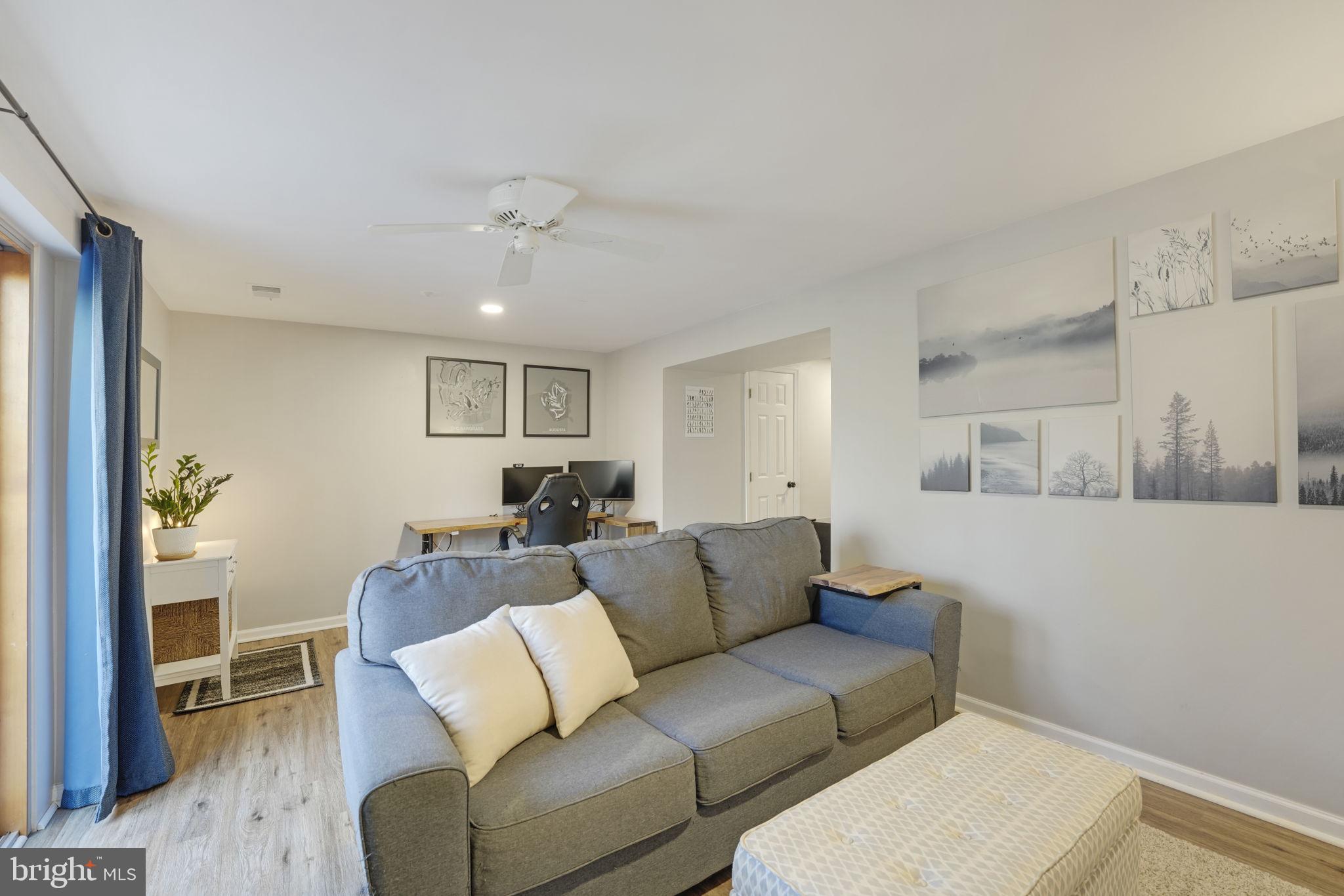 2310 Horseferry Court Reston, VA 20191 - Photo 40 of 49 a living room with furniture and a ceiling fan