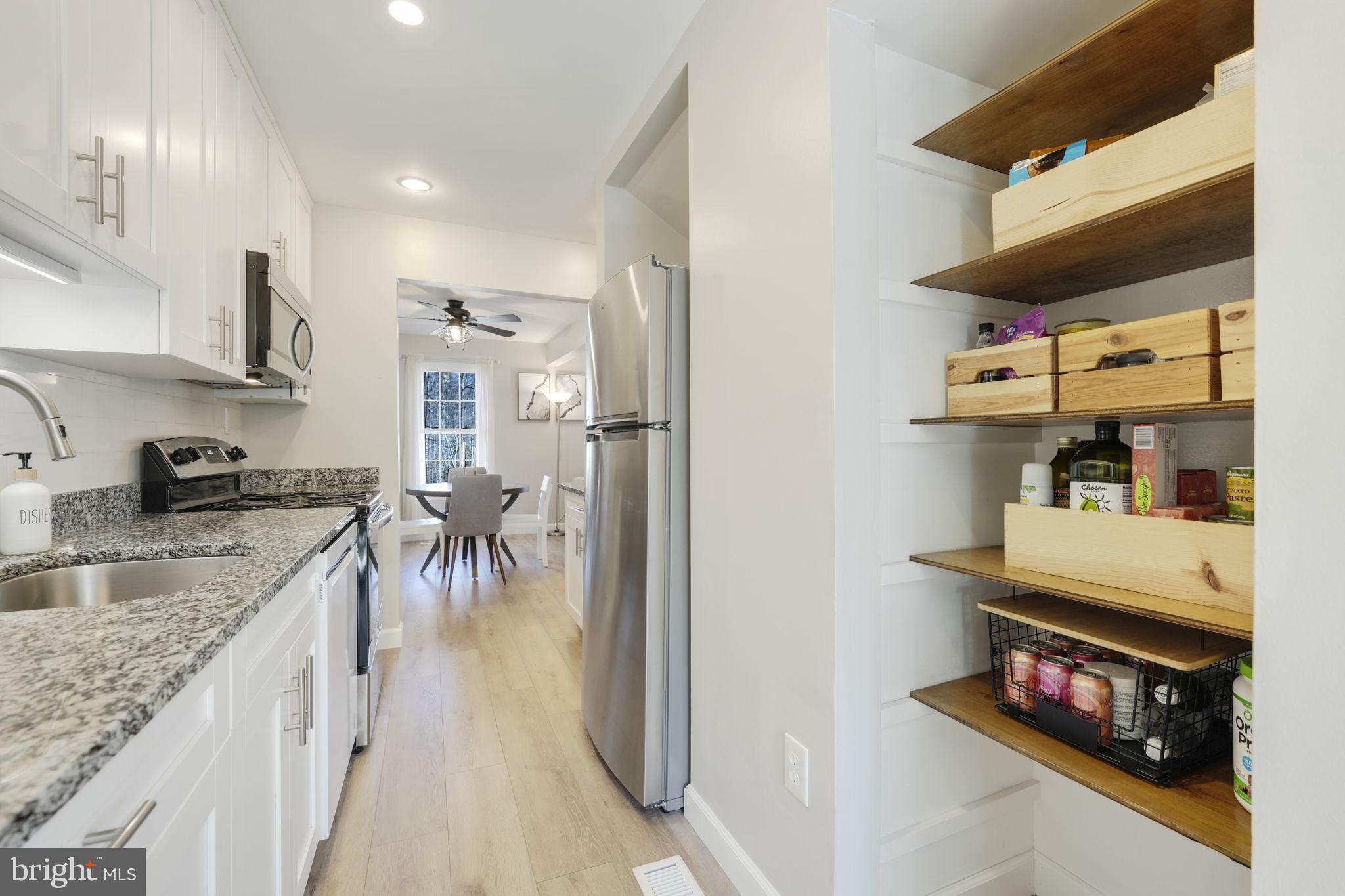 2310 Horseferry Court Reston, VA 20191 - Photo 8 of 49 a kitchen with stainless steel appliances granite countertop a sink stove and cabinets