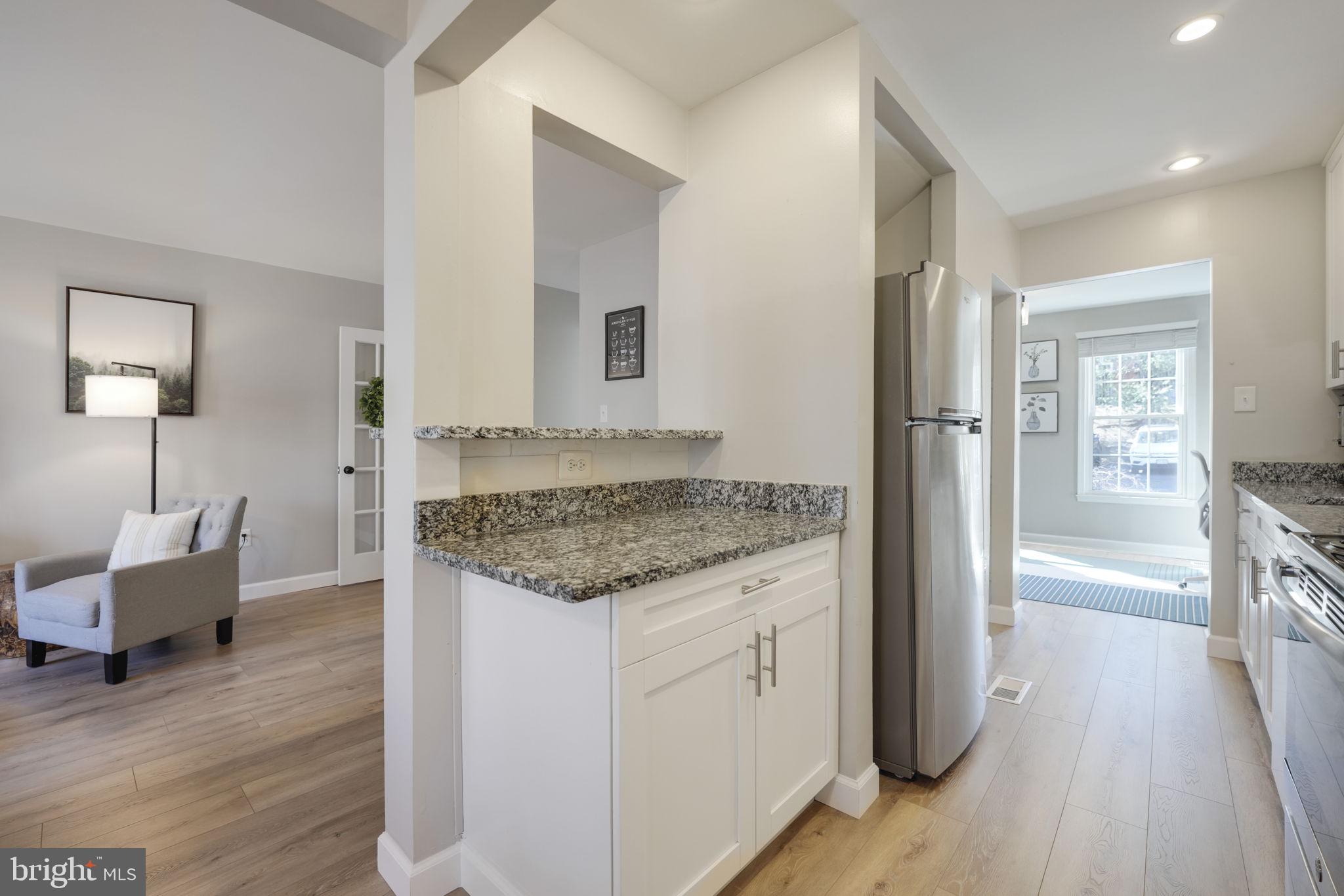 2310 Horseferry Court Reston, VA 20191 - Photo 9 of 49 a spacious bathroom with a granite countertop sink and a mirror