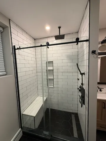 a bathroom with a shower and a sink