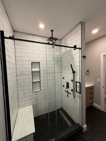 a bathroom with a shower and a sink