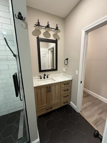 a bathroom with a sink a mirror and vanity