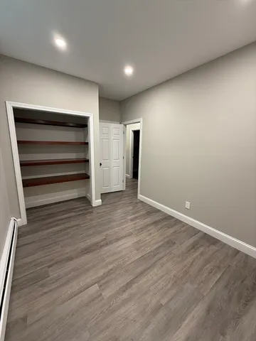 a view of room with wooden floor