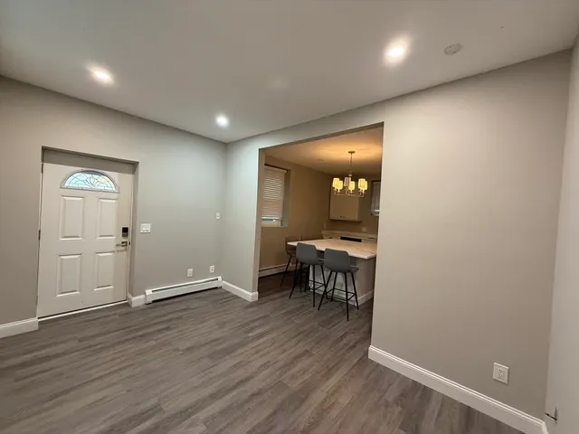 a view of a room with wooden floor and furniture