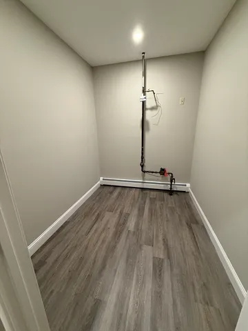 a view of a room with wooden floor and fan