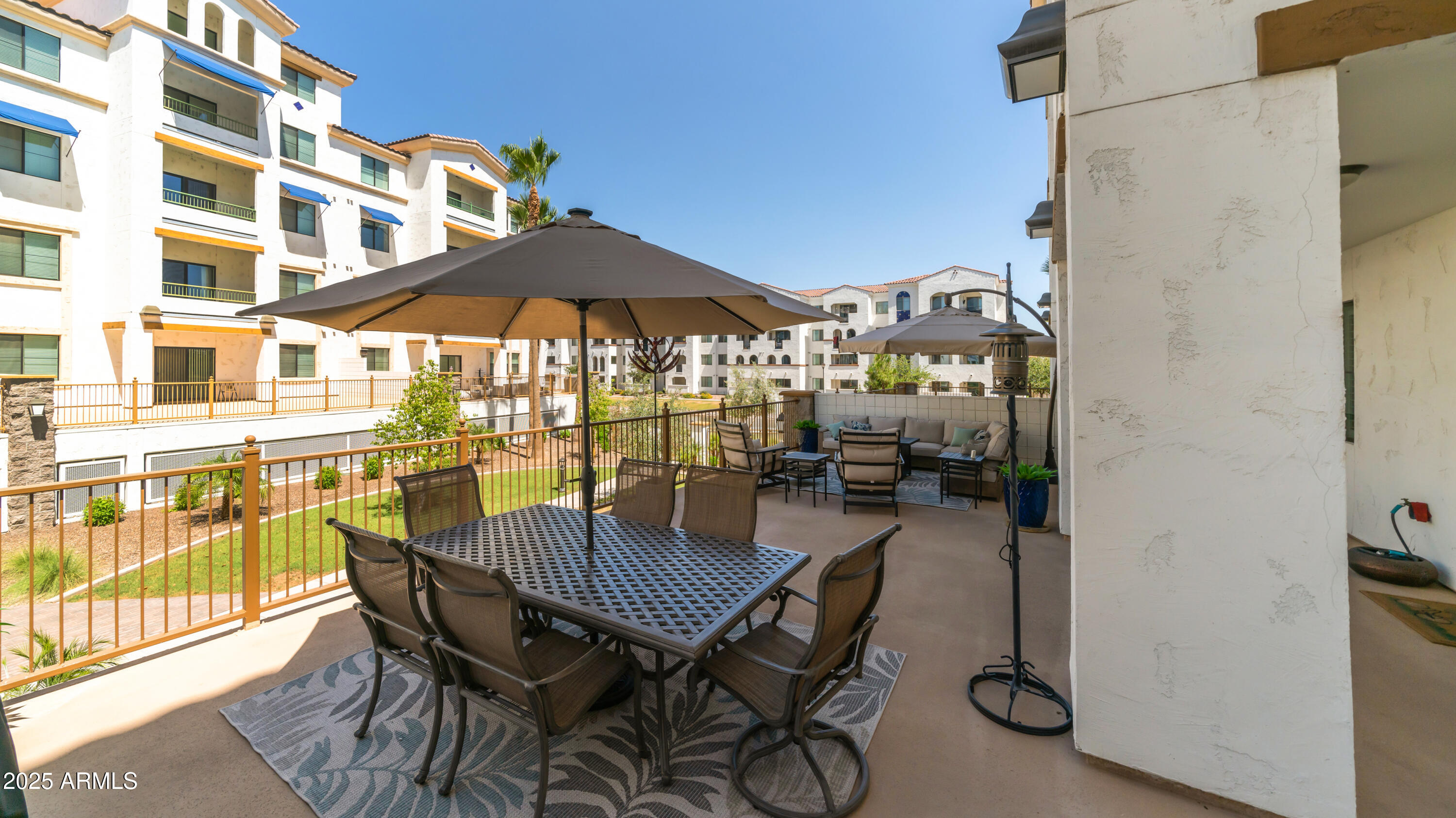 2511 West Queen Creek Road, Unit 166 Chandler, AZ 85248 - Photo 27 of 66 a view of a roof deck with table and chairs under an umbrella