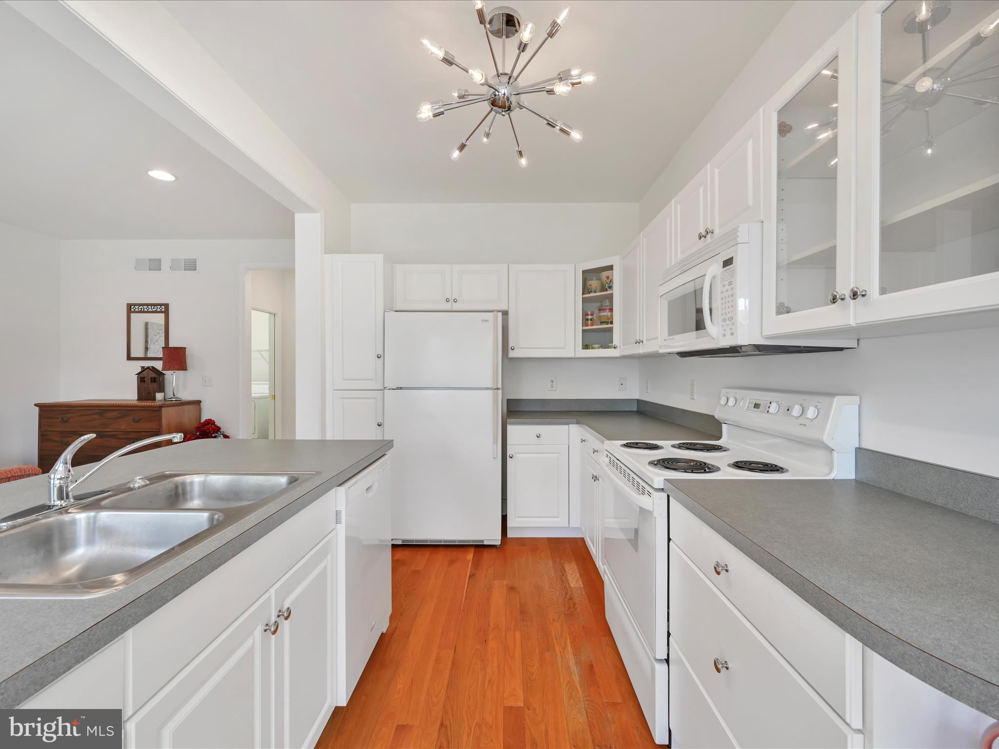 1082 Stillwood Circle Lititz, PA 17543 - Photo 12 of 44 a kitchen with stainless steel appliances granite countertop a sink stove and refrigerator